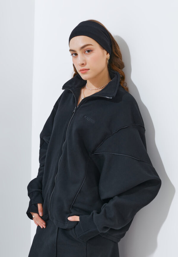 Kalerd black convertible sweater to bag worn as a sweater